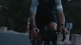 Professional road cyclists during hard training. Man and woman on road bikes ride epic forest mountain road during cycling holiday vacation tour or camp. Couple cyclists on carbon road bikes - Powered by Shutterstock - Get 15% off with code: PIKWIZARD15