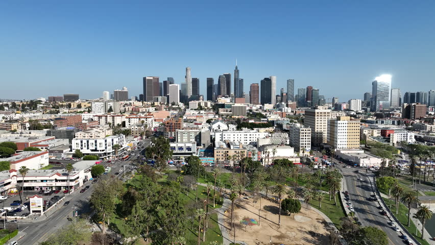 Los Angeles Downtown and Palm Trees from MacArthur Park Aerial Shot Forward Down in California USA