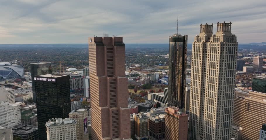 Atlanta Aerial v765 low descending drone fly through in between high rise buildings, reveals olympic park and surrounding attractions during autumn season - Shot with Mavic 3 Cine - November 2021