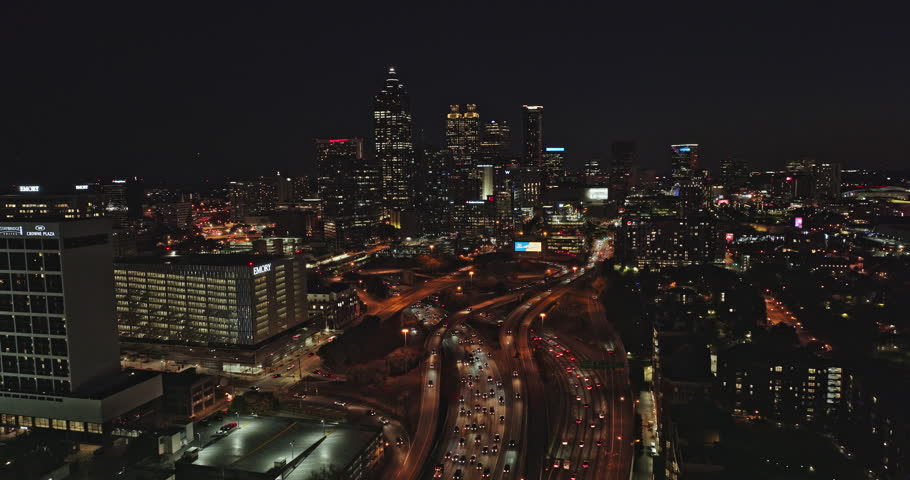 Atlanta Aerial v761 cinematic pan shot capturing illuminated downtown cityscape of central business district and busy freeway traffics and lit up skyscrapers - Shot with Mavic 3 Cine - November 2021
