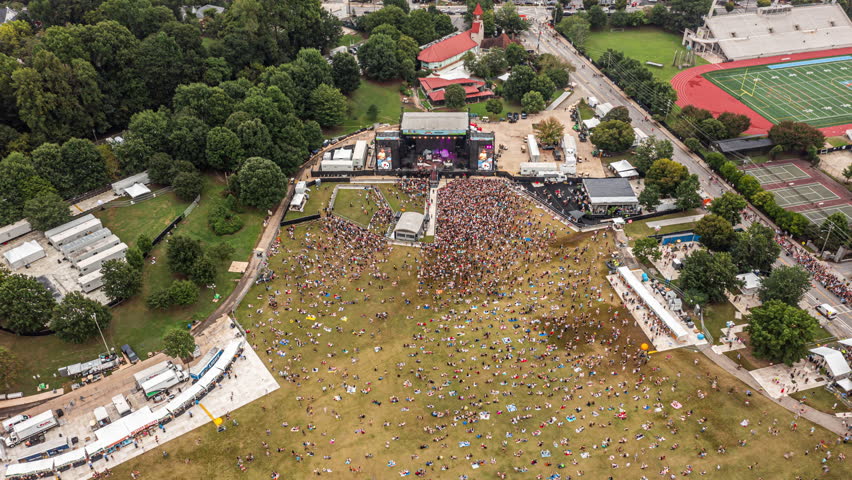 Atlanta Georgia Aerial v732 drone hyperlapse birds eye view across midtown piedmont park with outdoor music festival - September 2021