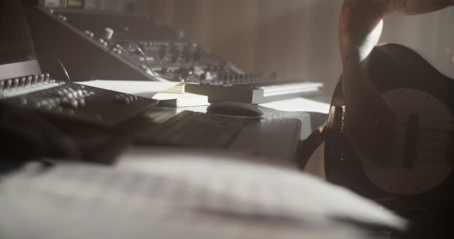 Man with bass guitar adjusting sound