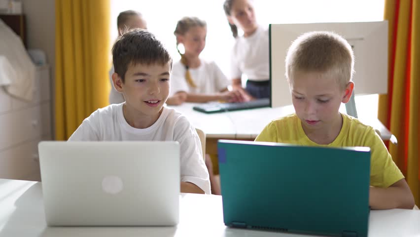 Happy team of friend.Children education at school with laptop.Children play together at computer as team.Online games for teaching teamwork at school in classroom.Online work learning laptop at school Royalty-Free Stock Footage #1108462153