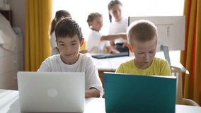 Happy team of friend.Children education at school with laptop.Children play together at computer as team.Online games for teaching teamwork at school in classroom.Online work learning laptop at school - Powered by Shutterstock - Get 15% off with code: PIKWIZARD15