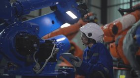 Factory engineer woman inspecting on machine with smart tablet. Worker works at machine robot arm. The welding machine with a remote system in an industrial factory. Artificial intelligence concept. - Powered by Shutterstock - Get 15% off with code: PIKWIZARD15