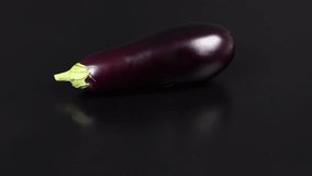 Eggplant on Black. Extrem close-up. Top view. Loop motion. Rotation 360. 4K UHD video footage 3840X2160.