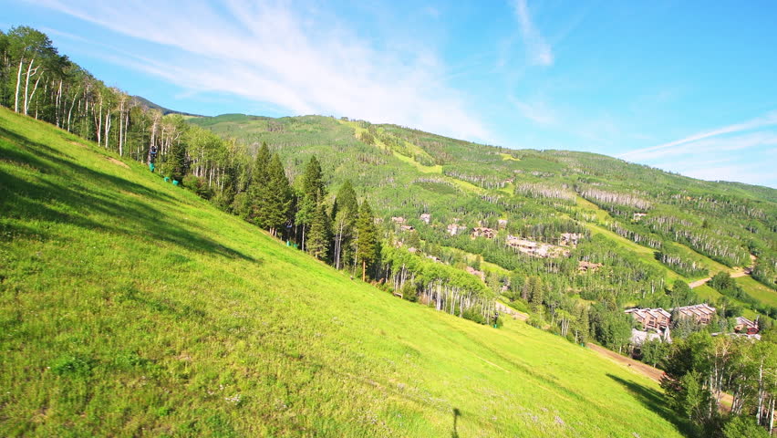 Beaver Creek Resort village by riding ski lift gondola cable car in summer at near Vail mountains pov point of view shot, houses home buildings
