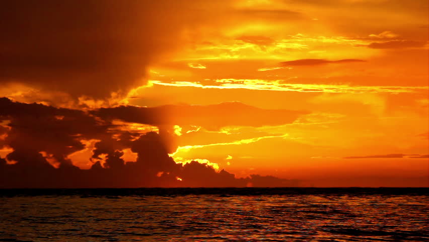 Dramatic seascape background during orange color sunset	