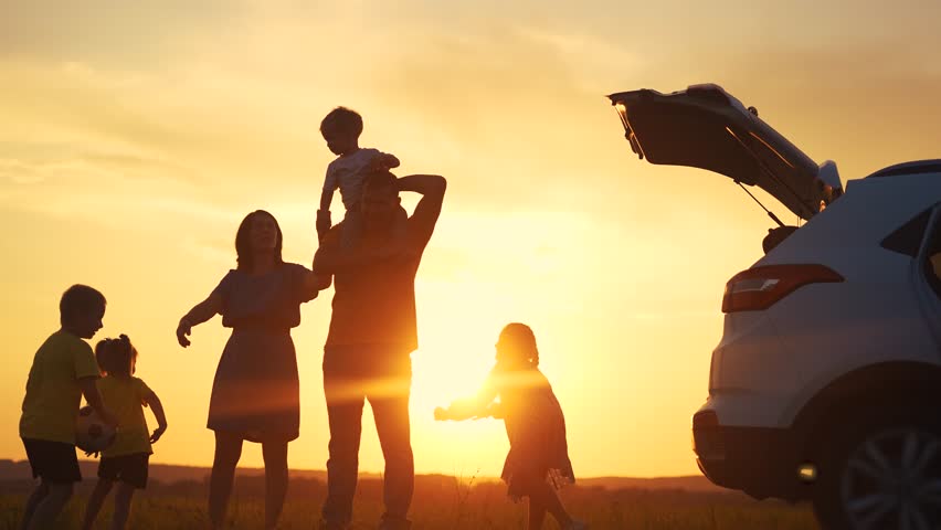 family by car resting in the park. family and children silhouette resting on the car playing ball at sunset in park on vacation. happy family kid dream concept sun. camping by car in the park Royalty-Free Stock Footage #1108477443