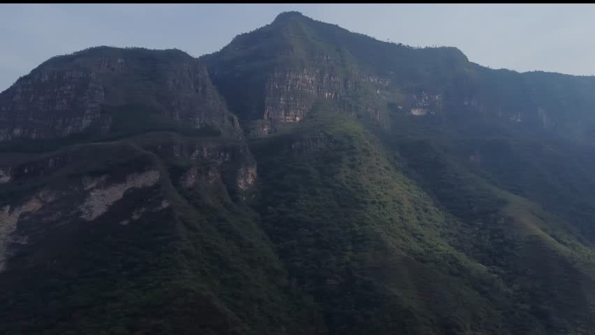 Gocta waterfalls Peru from far camera panning left to right along the mountains on a hazy morning