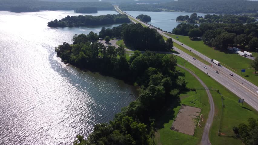 perfect view for the moving drone of over the high way in Alabama showing the rest area and the traffic during the week end  in a sunny day 