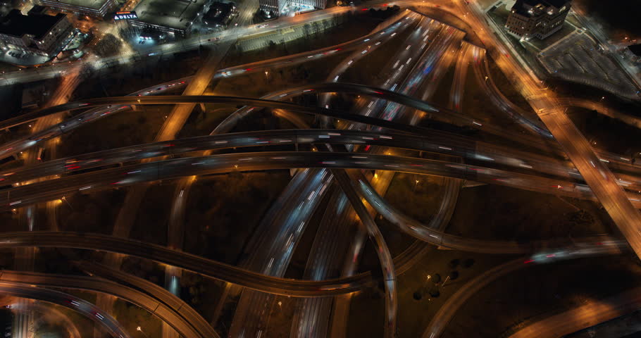 Atlanta Aerial v815 hyperlpase birds eye view capturing complex freeway traffic and cars light trail, tilt up capturing illuminated downtown cityscape at night - Shot with Mavic 3 Cine - December 2021