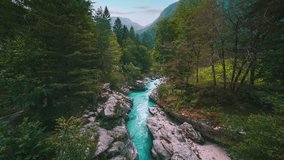 Soča mountain river in Triglav National Park Slovenia, Slovenian alps with forest tree nature. Blue water is rushing through a canyon with waterfall cascade and rocks. Cinemagraph seamless video loop