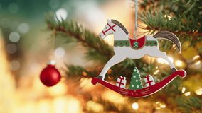 Christmas concept Christmas tree  decoration wooden toy horse rotate on branch tree on background bokeh of side flickering light bulbs garlands for family holiday Happy New Year. Festival mood - Powered by Shutterstock - Get 15% off with code: PIKWIZARD15