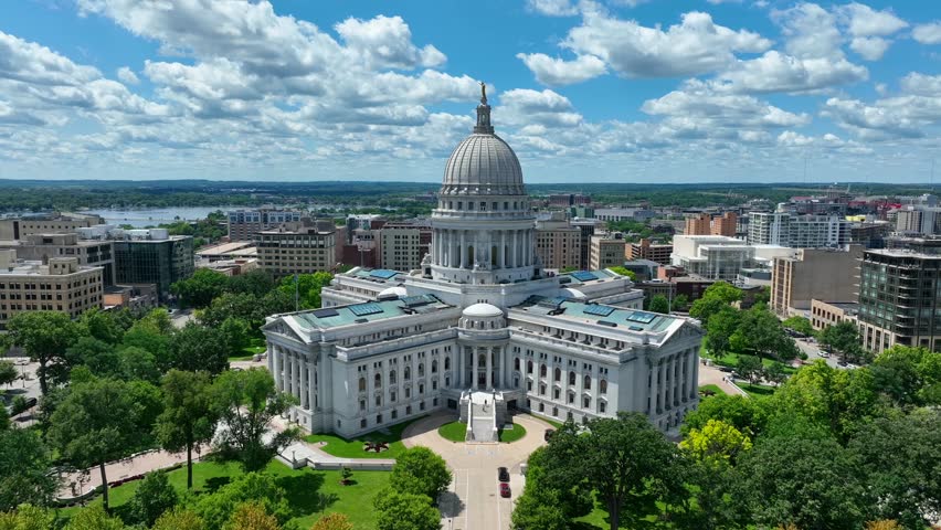 Capitol building of Wisconsin. Aerial reveal of Madison, WI capital city and grounds on beautiful summer day.