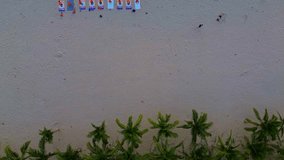 Landscape of My Khe beach, Da Nang, Vietnam with people practicing yoga, walking for exercise and waves in the morning filmed from above.  Beach and people.  Travel concept, ocean sea background.