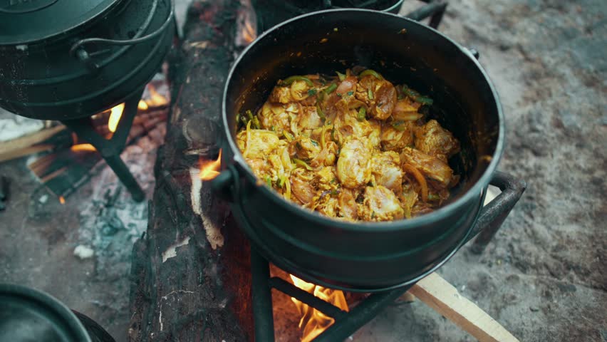 iron pot on fire cooking hot food stirring Royalty-Free Stock Footage #1108490047