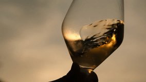 pouring white wine into a wine glass as sunsets, close up, fa01 - Powered by Shutterstock - Get 15% off with code: PIKWIZARD15