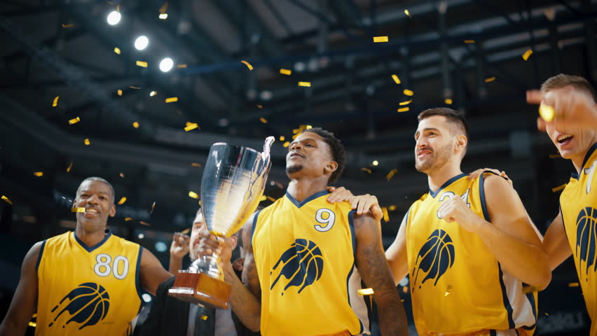 Multiethnic Basketball Players Celebrate Championship Victory with Hugs, Jumping, Holding the Trophy. Exclusive Joyful Sports Action on Live TV and Pay Per View Internet Streaming Royalty-Free Stock Footage #1108499929