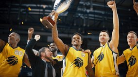 Multiethnic Basketball Players Celebrate Championship Victory with Hugs, Jumping, Holding the Trophy. Exclusive Joyful Sports Action on Live TV and Pay Per View Internet Streaming - Powered by Shutterstock - Get 15% off with code: PIKWIZARD15