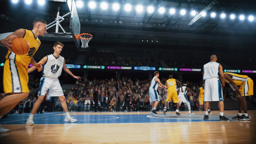 Cinematic College Basketball Tournament: Two Young Successful Diverse Teams Play a Championship Match in a Modern Arena. Excited African Player Scores a Slam Dunk with Two Hands and Hangs on a Hoop | Shutterstock HD Video #1108499939