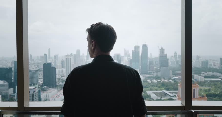 Back view Successful Business man in Skyscraper Looking out on Big City. Rear view Young Business man Standing on Balcony Business Buildings Skyline Cityscape. Big City Business concept Royalty-Free Stock Footage #1108500029