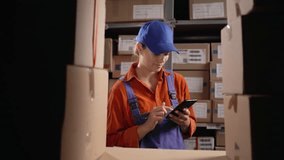 Young woman using touch screen mobile phone in warehouse storage. - Powered by Shutterstock - Get 15% off with code: PIKWIZARD15