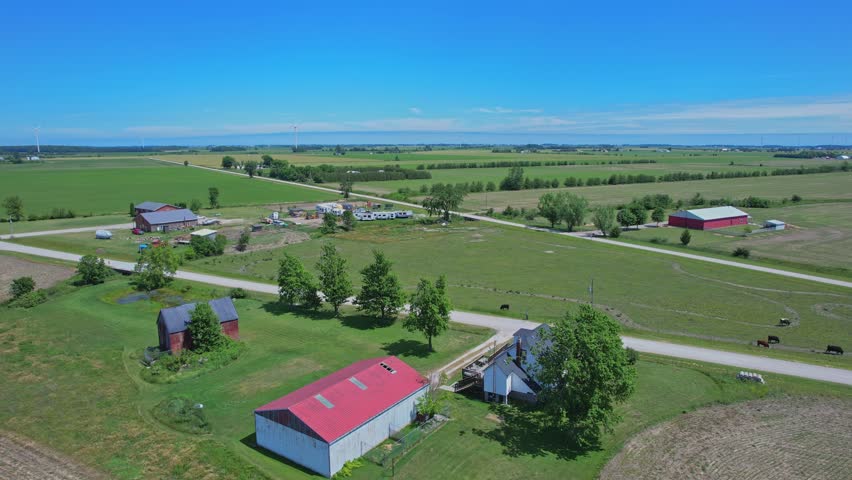 Shot of Canada south countryside at summer season, view from above. Farms and fields of wheat and crops. Rural Canadian county side landscape.