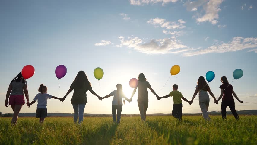 big family silhouette with balloons in park. large community family holding hands walking in nature silhouette in the park with balloons. happy family lifestyle kid dream concept Royalty-Free Stock Footage #1108508493