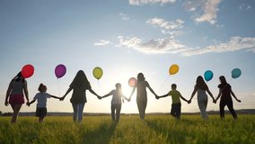 big family silhouette with balloons in park. large community family holding hands walking in nature silhouette in the park with balloons. happy family lifestyle kid dream concept - Powered by Shutterstock - Get 15% off with code: PIKWIZARD15