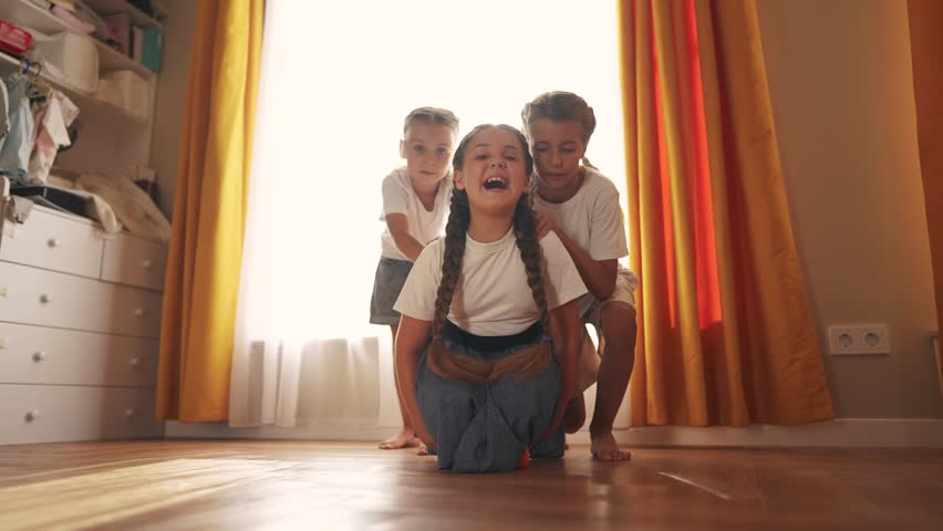 small children play at home and ride skateboard. happy family childhood dream concept. a group of little kids having fun together at home in a bright room. children smiling and laughing lifestyle Royalty-Free Stock Footage #1108508573