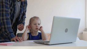 Dad shows daughter how to do a task from the Internet.