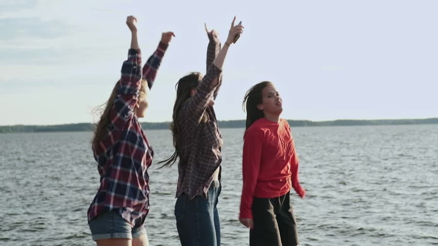 Happy Laughter female friends Listen Music and Dance in Summer Sunshine. High quality FullHD footage