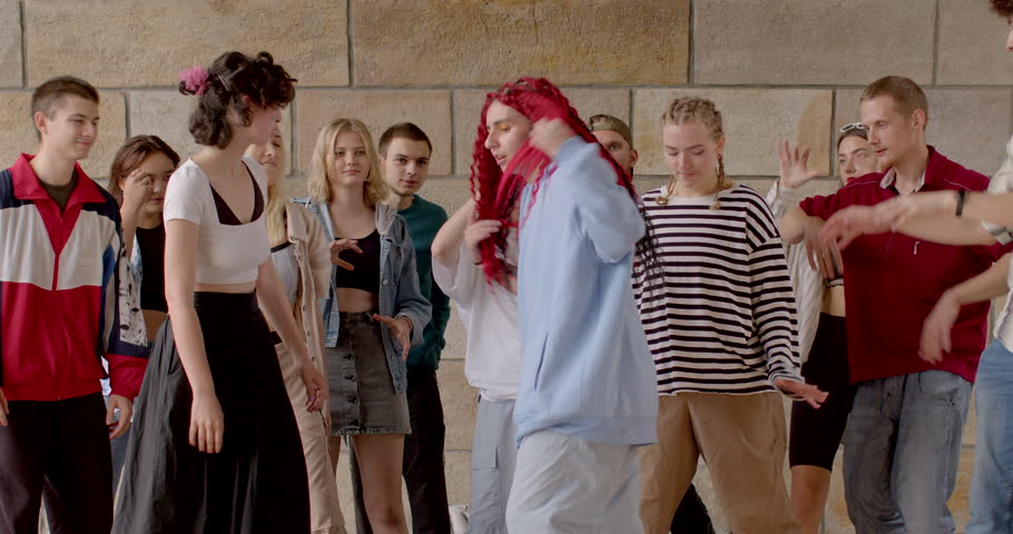 Dance master class at summer camp. Portrait of Young girl shows dance moves to group of students, active hand gestures. Foster a sense of community and camaraderie among dancers. Lifestyle people. | Shutterstock HD Video #1108521991