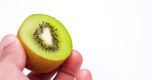 Video of hollowing out a kiwifruit with a spoon.
White background.