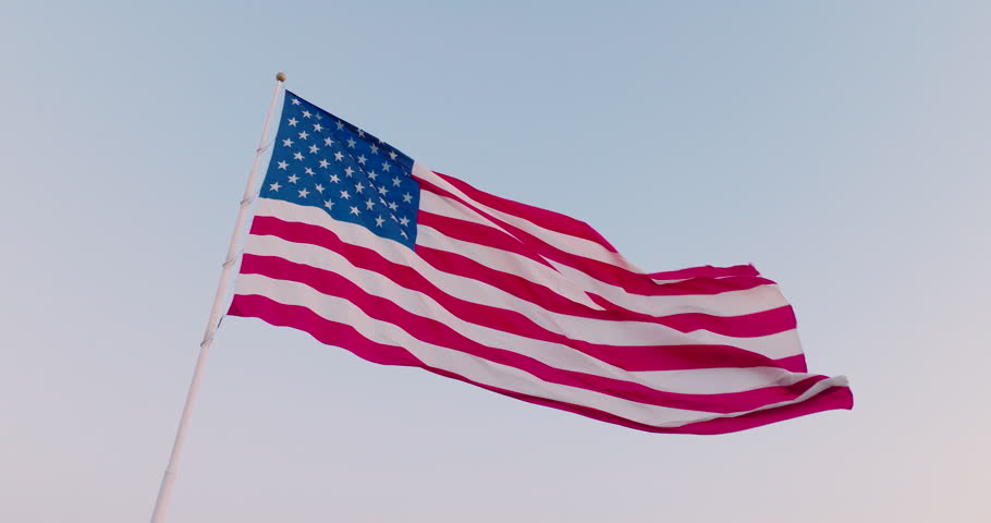 Cinematic view of an American flag waving in the wind at dusk as a symbol of freedom, July 4th, Independence Day, and the pride of the USA for democracy and political beliefs in this epic background. | Shutterstock HD Video #1108524685