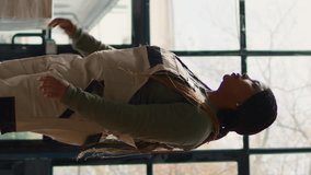 Vertical video Manager in warehouse using AR holographic technology to visualize how to best stash parcels on shelves to make room for more. Supervisor in distribution center uses augmented reality - Powered by Shutterstock - Get 15% off with code: PIKWIZARD15