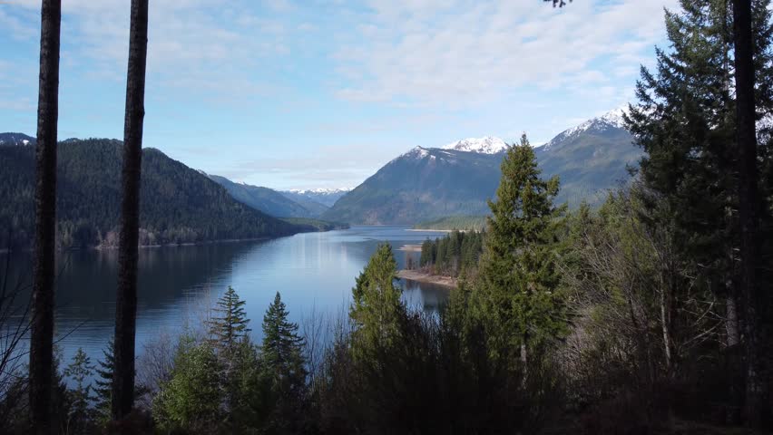 Lake Cushman with blue water and sunny skies. Olympic Mountains with snow. Washington State winter time.