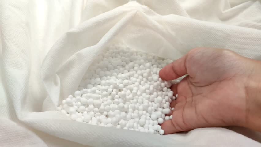 white styrofoam granules on cloth, usually used to fill bean bags or relaxing sofas. Cute