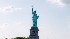 Video of the Statue of Liberty in the USA. The large, well-known statue. Architectural masterpiece. The sky is clear and blue with fluffy white clouds. History concept.