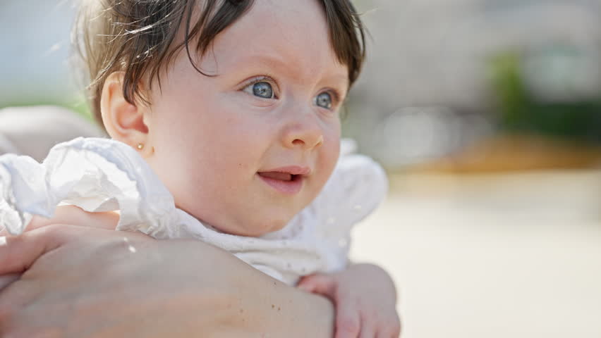 Mother and daughter hugging each other smiling at street