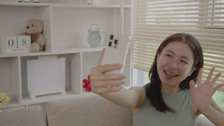 Young Asian woman greets his friends and colleague in a live video with a smile on his face, Online communication , Vdo call via phone, Social distancing, Internet learning. Royalty-Free Stock Footage #1108538177