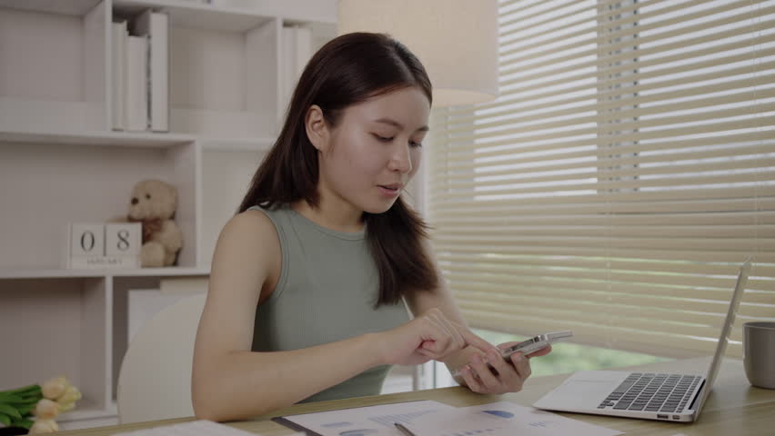 Woman working at home, Attractive woman chatting or talking with colleague on mobile phone at her home, Work for home, Remote conversation or meeting , Stay home, Use a cell phone or smartphone. Royalty-Free Stock Footage #1108538413