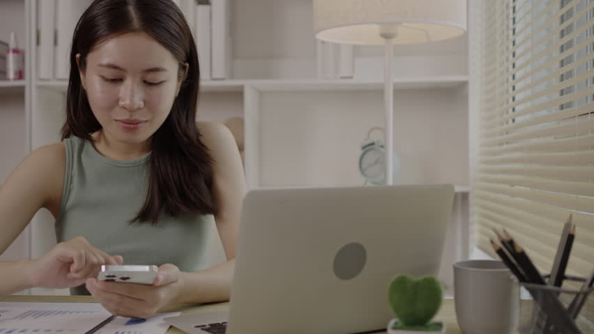 Woman working at home, Attractive woman chatting or talking with colleague on mobile phone at her home, Work for home, Remote conversation or meeting , Stay home, Use a cell phone or smartphone. Royalty-Free Stock Footage #1108538415