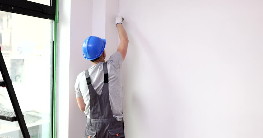 Master paints corner wall with brush white. Wall repair and painting Royalty-Free Stock Footage #1108540009