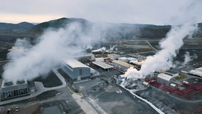 4K aerial video of geothermal energy plant, pipes and smoke chimneys. Iceland