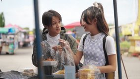 4K Young Asian man and woman buying and eating street food at railway station with using mobile app on smartphone scan QR code making online payment during travel local town on summer holiday vacation - Powered by Shutterstock - Get 15% off with code: PIKWIZARD15