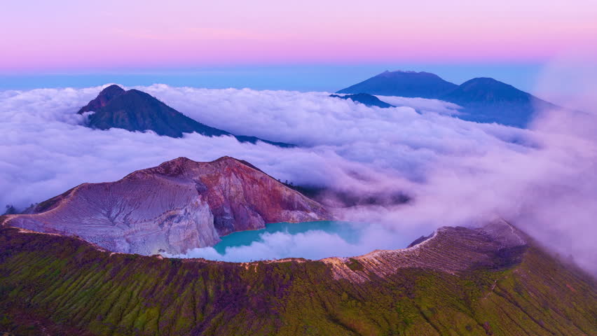 Aerial view Drone Hyperlapse of fog at Kawah Ijen volcano with turquoise sulfur water lake at sunrise.Amazing nature landscape view at East Java,Indonesia.Beautiful light Natural landscape background Royalty-Free Stock Footage #1108542347