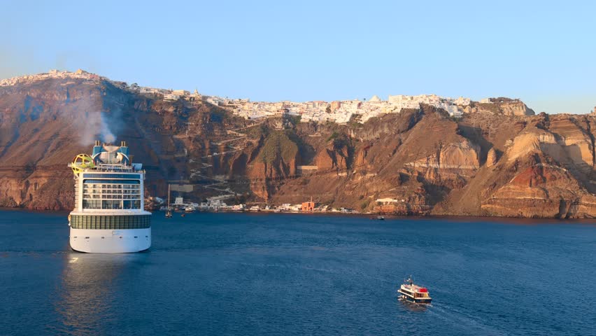 Greece Islands, cruise ship docked near Santorini island on a cruise vacation in Mediterranean.