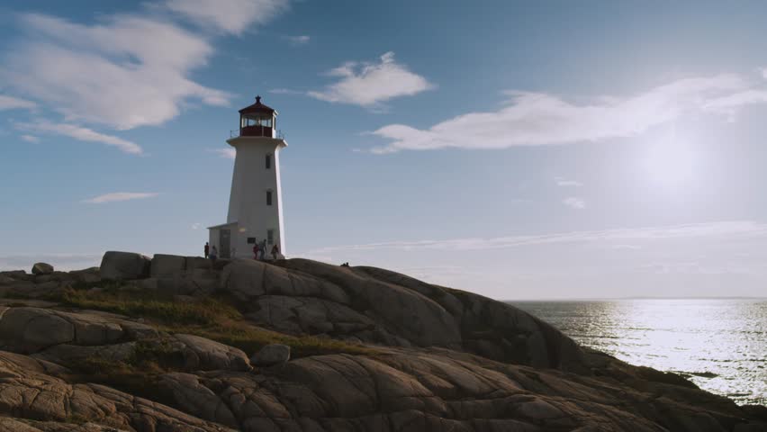 Cinematic Shot of an Ancient Lighthouse Standing on the Rocky Shore of the Atlantic Ocean On the Sunset. Peggy